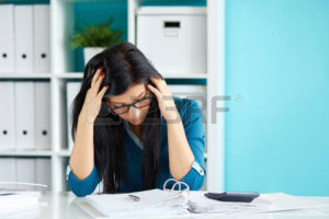 57152360-young-business-woman-under-stress-with-head-in-hands
